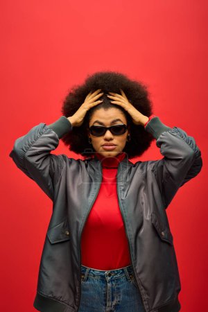Photo for A fashionable African American woman poses confidently in trendy attire against a vibrant backdrop. - Royalty Free Image