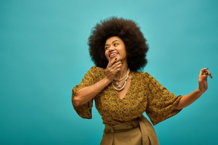 A stylish African American woman with curly hairdohairdo joyfully holds a piece of food.
