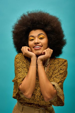 Photo for Stylish African American woman with curly hairdoposing on vibrant backdrop. - Royalty Free Image
