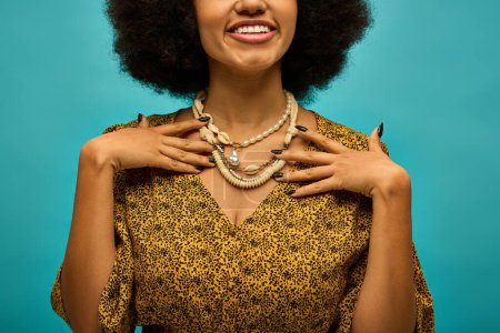 Photo for Stylish African American woman with curly hairdoposes on vibrant backdrop. - Royalty Free Image