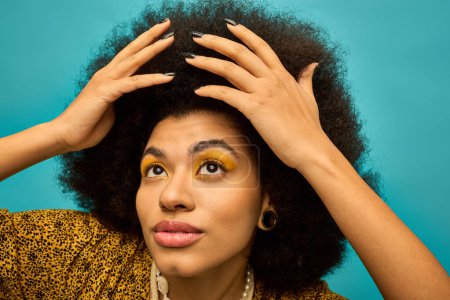 African American woman holding hair in front of face.