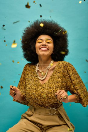 Photo for Stylish African American woman with curly hairdohair, dressed in trendy attire, sitting on a chair against a vibrant backdrop. - Royalty Free Image