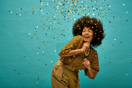 Photo for A stylish African American woman with curly hairdosurrounded by colorful confetti. - Royalty Free Image