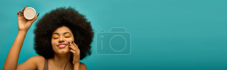 Photo for Stylish African American woman holding cream. - Royalty Free Image