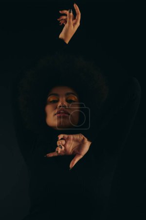 Photo for Stylish African American woman with hand raised in the air against a vibrant backdrop. - Royalty Free Image