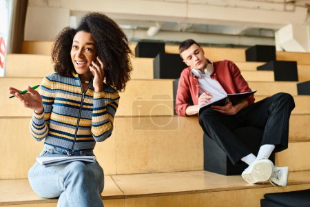 Téléchargez les photos : Une fille noire parlant sur un téléphone portable à côté d'un homme dans un cadre de salle de conférence - en image libre de droit