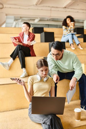 Photo for Multicultural group of students, including an African American girl, sitting in a lecture hall, focused on their education - Royalty Free Image