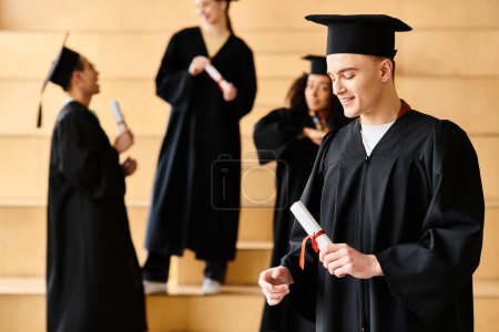 Un hombre diverso en un vestido de graduación orgullosamente sostiene su diploma.
