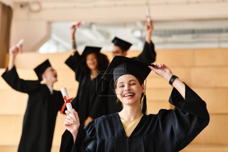 Photo for A diverse group of students in graduation gowns and mortars celebrating their academic success. - Royalty Free Image