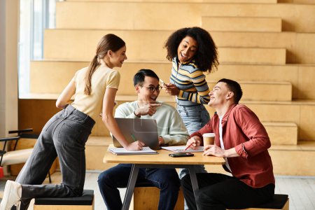 Photo for Students of various backgrounds sit together at a wooden table, engaged in conversation and teamwork. - Royalty Free Image