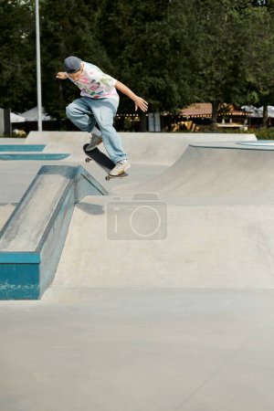 A young skater boy confidently rides a skateboard up the ramp at an outdoor skate park on a sunny summer day.