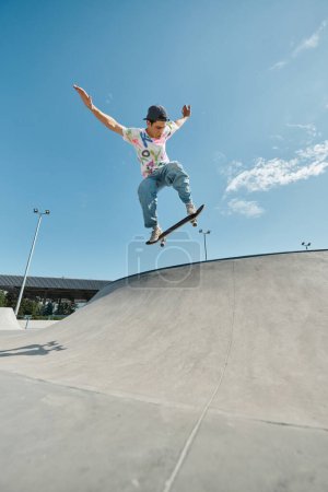 A young skater boy daringly rides his skateboard up a steep ramp at a skate park on a sunny summer day.