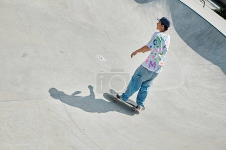A young skater boy performing a daring skateboard descent down the ramp at an outdoor skate park on a sunny summer day.