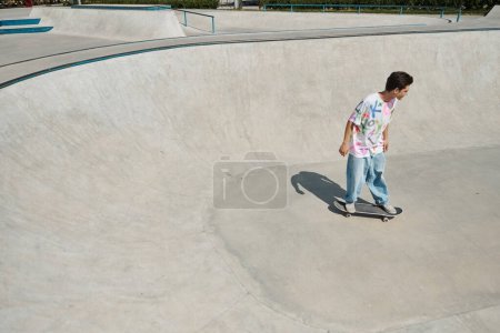 A young skater boy gracefully maneuvers his skateboard at a bustling skate park on a sunny summer day.