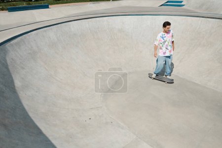 A young man skillfully rides his skateboard at a vibrant skate park on a sunny summer day, showcasing his tricks and talent.