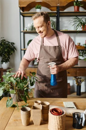 A man in an apron holds a spray bottle in a plant shop, showcasing his expertise in nurturing greenery for his small business.