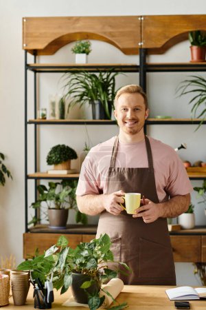 Téléchargez les photos : Un homme élégant dans un tablier dégustant une tasse de café dans un magasin de plantes, incarnant le propre concept d'entreprise. - en image libre de droit