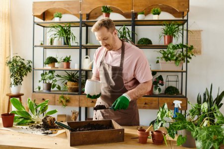 A man in an apron and gloves tenderly waters a variety of lush plants in a vibrant plant shop.