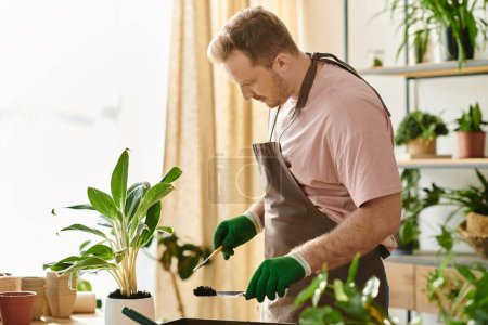 A man in an apron and green gloves expertly prepares a potted plant in a charming plant shop setting.