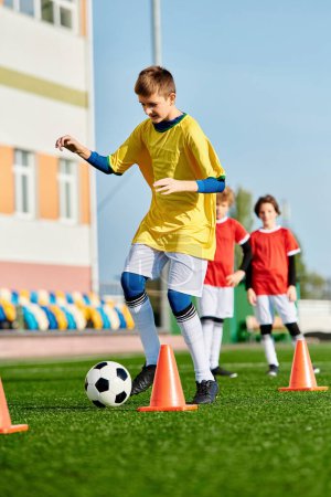 A lively group of young boys kicking a soccer ball around cones on a vibrant field, showcasing teamwork and skill in action.