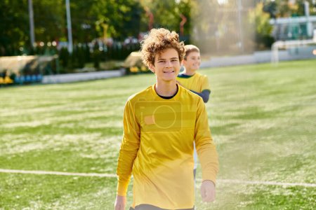 Photo for Two young men celebrate their victory by standing on top of a soccer field, showcasing their joy and camaraderie. - Royalty Free Image