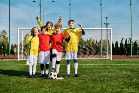 A group of young children, filled with energy and enthusiasm, stand triumphantly on top of a soccer field, celebrating their teamwork and victory.