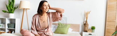 A mature woman in cozy homewear relaxing on a bed in a room.