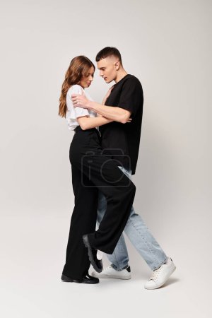 A man and woman gracefully sway together in an intimate dance, showcasing their love and connection.