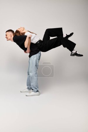A man gracefully carries a woman on his back, showcasing strength, trust, and the bond between a loving couple.