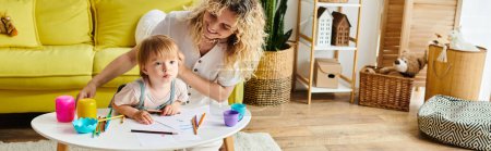A mother with curly hair and her toddler daughter engaged in Montessori learning at a table at home.