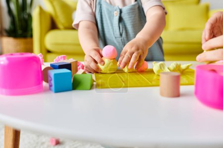 A mom guides her little girl through Montessori learning with colorful blocks and shapes.