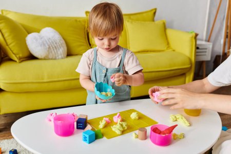 A curly mother watches as her toddler daughter engages with Montessori toys on a table at home, fostering creativity and learning.