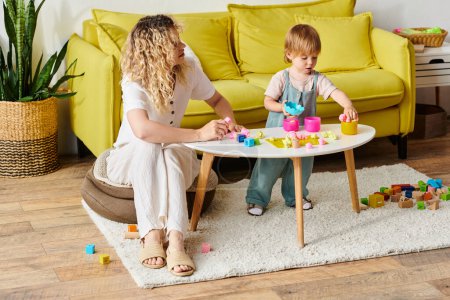 A mother with curly hair engaging her toddler daughter in Montessori play and learning in a cozy living room.