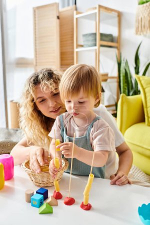 A curly mother and her toddler daughter are happily playing with toys, practicing the Montessori method of education at home.
