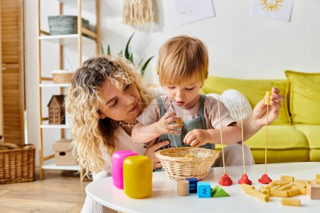 A curly mother and her toddler daughter are happily playing with toys, engaging in Montessori education at home.