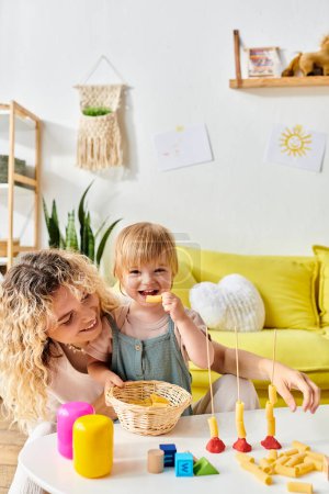 Curly mother and toddler daughter immersed in Montessori education at home.