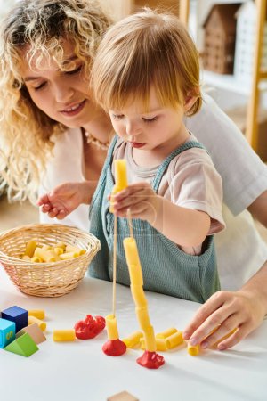 A curly-haired mother and her toddler daughter engage in the Montessori method, joyfully building and playing