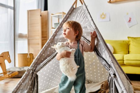 Photo for Toddler girl cuddling a stuffed animal inside a teepee, creating a magical and imaginative playtime setting at home. - Royalty Free Image