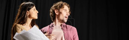 Photo for A man and woman rehearsing together, holding a piece of paper. - Royalty Free Image