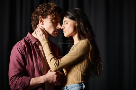 A man and a woman standing together, rehearsing for a theater performance.