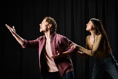 Photo for A handsome man and a woman rehearsing on a stage. - Royalty Free Image