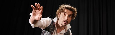 Photo for A man with curly hair pulls a confident face. - Royalty Free Image