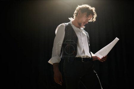 Photo for A man in a vest holding a piece of paper - Royalty Free Image