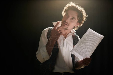 A man engrossed in a script, captivated by its contents.