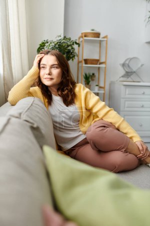 Middle-aged woman peacefully relaxes on couch in cozy living room