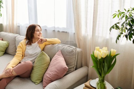 Middle-aged woman sitting comfortably on a couch in a cozy living room.