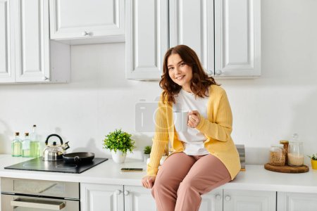 A middle aged woman sitting gracefully on a kitchen counter.