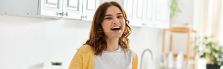 Middle-aged woman looking surprised in modern kitchen.