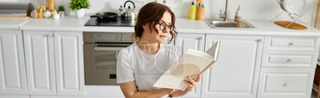 A middle-aged woman engrossed in a book while seated in a cozy kitchen.