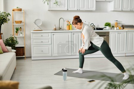 Mujer de mediana edad realiza con gracia una pose de yoga en una esterilla de yoga en casa.